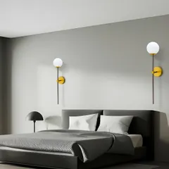 This simple and elegant wall sconce with a globe light is perfect for a modern bedroom. Using one on each side of the bed creates a balanced and sophisticated look.