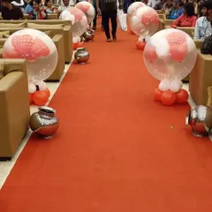 Balloon decorations lining the aisle for a wedding ceremony or reception entrance.