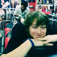 A happy client is the goal of every tattoo artist. This photo shows a client from overseas, smiling while getting her tattoo, which is the kind of professional and comfortable environment I maintain.