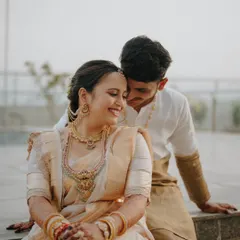 A candid, happy moment between the couple, dressed in elegant cream and gold traditional wear. I look for these unposed interactions that show the genuine connection you share.