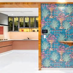 A view from the foyer into the kitchen, where a bold, patterned wallpaper wall contrasts beautifully with the warm tones of the kitchen cabinetry, creating a visual journey through the home.