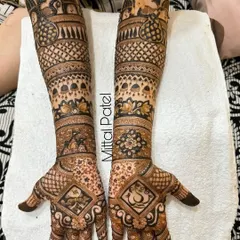 This heavy bridal design is filled with classic motifs, including peacocks in the palms, Ganesha figures, and intricate jali (lattice) work.