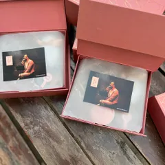 The unboxing experience begins. Here you see the personalized boxes for a book launch, with a photo card of the author placed on top, immediately connecting the recipient to the story.