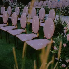 The details matter. For this ceremony, we designed custom upholstery for the chairs that perfectly matched the soft, romantic aesthetic of the floral arrangements and mirrored mandap.
