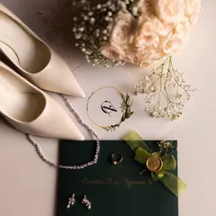 An elegant flat lay of the bride's accessories, including her shoes, jewelry, and the wedding invitation, telling the story of her day.