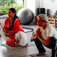 In our senior classes, we focus on foundational poses like Malasana (Garland Squat) to improve hip mobility and strength, with a focus on mindful movement.