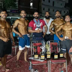 The whole team celebrating. I stand with my clients every step of the way, from the first day in the gym to their victory on the competition stage.