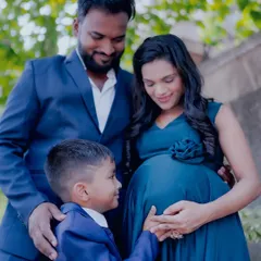 An outdoor family maternity portrait is a wonderful option. The natural environment creates a relaxed and happy atmosphere, perfect for capturing genuine family moments.