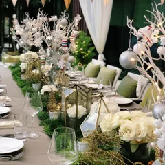 Another view of the elegant Christmas dinner table, showcasing the layered decor of lanterns, candles, and festive ornaments that create a warm and inviting atmosphere.