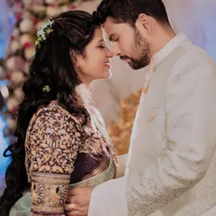An intimate forehead-to-forehead pose, capturing the deep connection between the couple. The soft lighting and their gentle smiles make this a truly romantic shot.