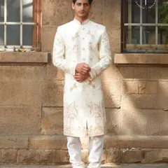 A full view of our ivory sherwani featuring unique horse and palm motifs. This piece tells a story with its detailed embroidery, offering a modern take on traditional groomswear. It’s perfect for the groom looking for something distinctive.