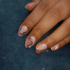 A subtle and chic design using a silver chrome gel to create delicate, abstract lines over a neutral pink base.