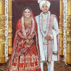 A close-up of the finished portrait from the live wedding painting in Raipur. The intricate details of the bride's red lehenga and the groom's sherwani are highlighted.