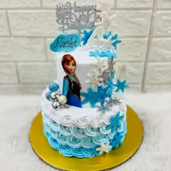 Let it go with a magical Frozen themed cake. This two-tiered design for a 4th birthday features Anna, a cascade of shimmering snowflakes, and a beautiful blue ombre frosting.