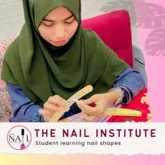 A student gets hands-on practice learning different nail shapes, a fundamental skill for any nail technician.