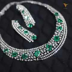 A modern take on a classic design, this emerald and diamond necklace is perfect for the contemporary woman. The clean lines of the emerald-cut stones make it both elegant and edgy.
