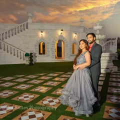 A beautiful sunset shot at our white villa set. The warm evening light adds a romantic glow to this elegant couple's portrait.