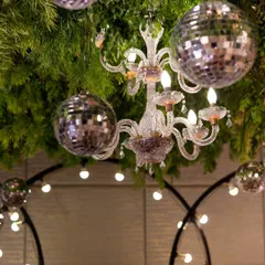 A close-up of the Sangeet ceiling decor, where we mixed lush greenery with sparkling disco balls and classic chandeliers. This fusion of elements created a fun, glamorous, and festive party atmosphere.