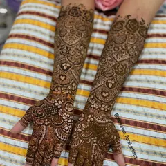 This detailed design was for an engagement bride. It features delicate hearts and intricate netting, covering the hands and arms completely for a traditional look.
