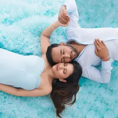 This creative overhead shot captures a quiet, intimate moment between the expecting parents. The unique perspective and serene expressions make for a beautifully artistic and memorable photograph.