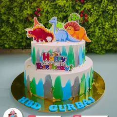 A dino-mite two-tier dinosaur cake for Gurbaz. This colourful cake with different types of dinosaurs is perfect for a Jurassic-themed party.
