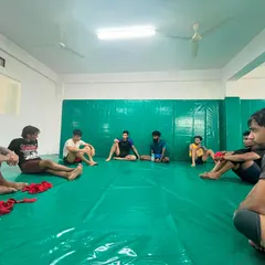 A moment of rest and discussion after a tough training session. We believe in breaking down techniques and strategies as a team.