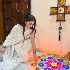 Manifesting all the good vibes this Diwali. A serene moment lighting diyas in a beautiful all-white sharara set, embracing the festive spirit.