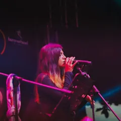 My talented vocalist, lost in the melody during our show at The Night Market. Each member of the band brings their own unique soul to the performance.