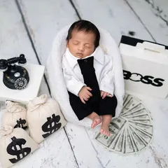 The 'Boss Baby' in charge. This theme is full of character, with a tiny business suit, a vintage telephone, and bags of money for a humorous and adorable shot.