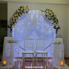 Another view of the classic white anniversary decor. The soft lighting from the fairy lights and candles creates a warm and romantic ambiance, perfect for an intimate celebration at home.