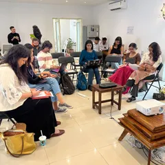A focused shot of our 'Verse & Voice' workshop in session. We create a studious yet comfortable atmosphere for deep learning and creative exploration.