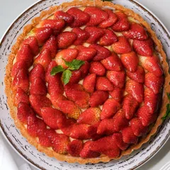A celebration of the season in our stunning strawberry tart. This dessert features a buttery pastry crust, creamy crème pâtissière, and a beautiful arrangement of fresh, juicy Mahabaleshwar strawberries, making it a perfect centerpiece for any occasion.