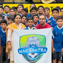 A close-up of our players and their families, holding the Nakshatra FC banner with pride before heading to the tournament in Ahmedabad.