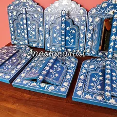 Inspired by the ornate windows of Rajasthani palaces, I hand-paint these wooden Jharokha frames. This collection shows the variety of designs available, each featuring delicate floral patterns and some with mirrors, adding a touch of royal elegance to your wall decor.