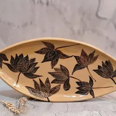 This special giant platter, measuring 13 inches, is a true statement piece. It is hand-painted with intricate lotus motifs and can be used to serve treats or as a decorative fruit bowl.