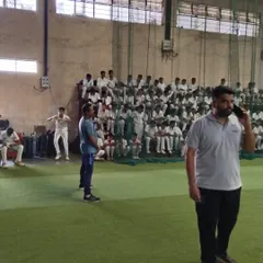 The indoor facility packed with young cricketers during selection trials, all waiting for their chance to impress the coaches.