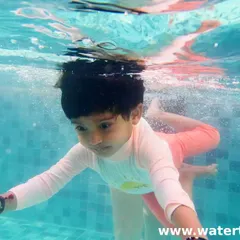 Look at this little fish go! This underwater shot captures a Level 2 student mastering her skills. We celebrate every milestone, big or small.