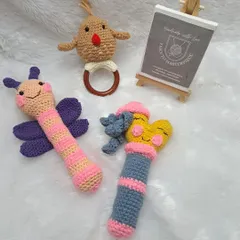An assortment of my handmade baby rattles, including a bird, a butterfly, and another fun character design.