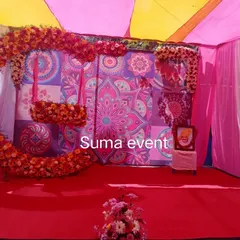 This vibrant setup was for a naming ceremony, but it's also perfect for a Haldi or Mehendi function. It includes a colorful mandala-print backdrop, bright pink and yellow drapes, and a custom floral swing for the perfect photo opportunity.