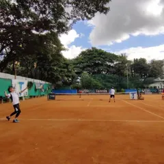 A young player honing her skills on our expansive clay court. The playing surface is consistently prepared to provide a true and reliable bounce.