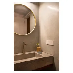 This bathroom in the 'House of Skye' features pastel green terrazzo walls and a custom-cast slate grey terrazzo sink. The seamless finish and the meeting of two different terrazzo colors in one space is a detail I particularly love.