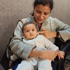 A mother, who was part of our prenatal program, lovingly holds her baby. Our classes are designed to empower women through their pregnancy, fostering a sense of calm and confidence.