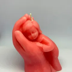 A flame cradled with love. This candle captures the warmth of a mother's hands and the innocence of a child, a truly special piece.