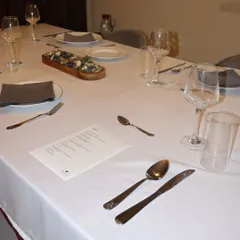 A close-up of the table, ready for guests. Fine cutlery, proper glassware, and a custom menu are all part of the comprehensive private chef service I provide.