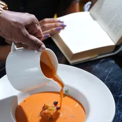 From velvety soups to bold plates, my four-course lunch is its own mood. Here, a creamy tomato soup is poured at the table.