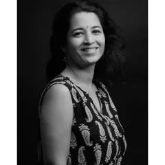 A spontaneous and joyful black and white portrait. This image captures a genuine smile and a moment of authentic happiness, showing the beauty in candid shots.