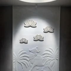 God is in the details. Here, a traditional Pichwai art panel, depicting a sacred cow and lotuses, is carved in white marble. Lit from a skylight above, it becomes a serene and spiritual focal point in the home.