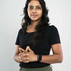 A classic waist-up professional portrait against a clean white background. This style is versatile and focuses entirely on the subject's expression, making her look approachable and confident for her professional profile.