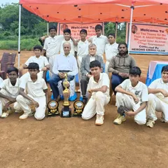 The team poses with officials and their trophies after a successful tournament.