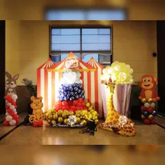 A fun photo corner at the carnival party, featuring a giant popcorn box made of balloons and friendly animal cutouts.